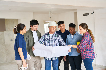 Various coworkers and architect meeting over blueprintの写真素材