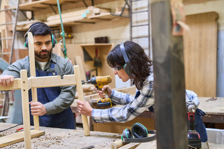 A young apprentice collaborates with an experienced mentor in a lumberyard, focusing on teamwork and...