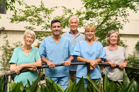 A rehabilitation facility with friendly staff and happy seniors enjoying the outdoor space together.の写真素材