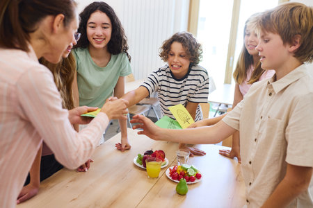 A cheerful group of students engaging with each other in a cafeteria, featuring healthy snacks and...
