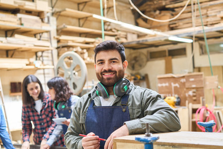 Smiling young professionals working together in a bustling lumberyard. Emphasizing teamwork,...