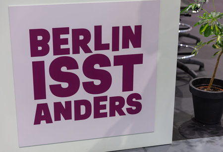 BERLIN, GERMANY, January 16th 2026: Photo of Signage for the Berlin food fair is displayed with a plant at the Internationale GrÃ¼ne Woche trade show in Germany The sign promotes regional food and culinary experiences.のeditorial素材
