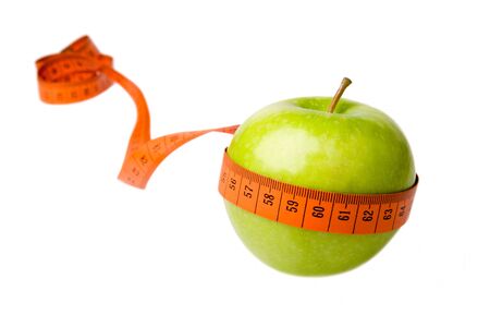 Green apple and measuring tape isolated on a white backgroundの写真素材