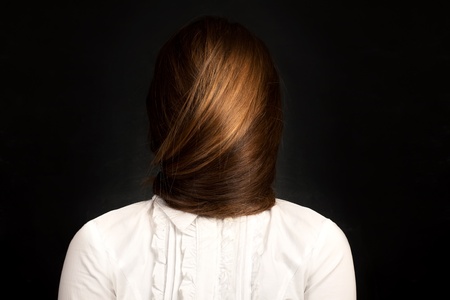 Conceptual photo of young woman with very long hair which covers her face.  の写真素材