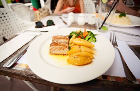 grilled tuna with potatoes and greensの写真素材