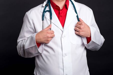 the pediatrician holds a stethoscope and is ready to receive the patientの写真素材