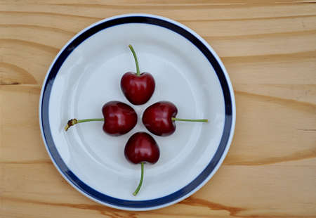 plate with shiny cherriesの写真素材