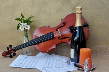 romantic scene with sheet music, flowers and candleの写真素材