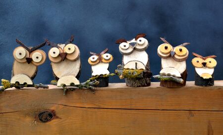 Row owls handmade on woodの写真素材