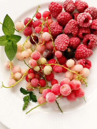 Frozen berries on a white plateの写真素材