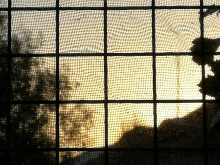 Window of a prison at sunset