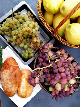Basket with grapes and lemonsの写真素材