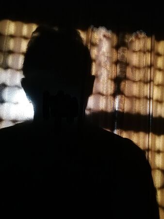 silhouette of a person on a wood with spots of light