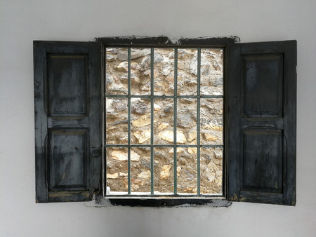 wall with window, fence and stone wallの写真素材