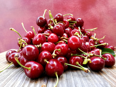wooheap of cherries on old wooden