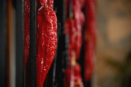 driying red pepper hanging on fenceの写真素材