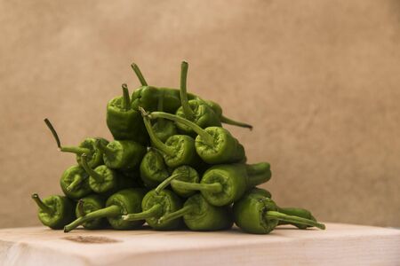 sweet green peppers bunch on a kitchen boardの写真素材