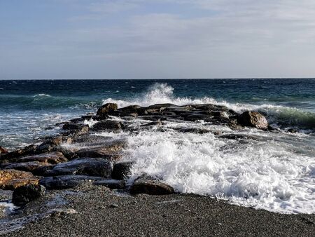 sea â€‹â€‹with waves and rocks on an autumn afternoon