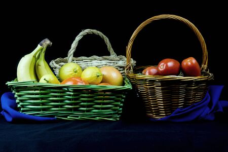 wicker basket with fruits in background with elegant clothの写真素材