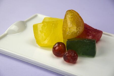 candied orange and others fruits on white tray and bright backgroundの写真素材