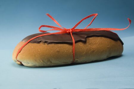 chocolate bun tied with a red pastry ropeの写真素材