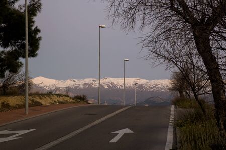 mountain road with snow in the background