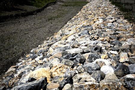 stone wall next to a dry stream bed