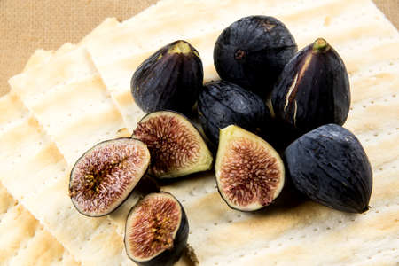 ripe black-skinned figs on wafersの写真素材