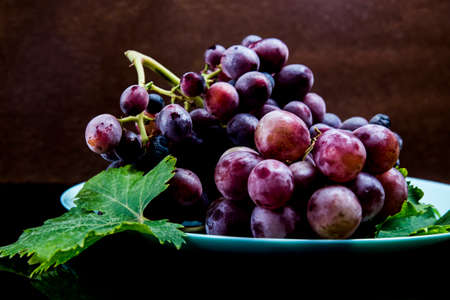 ripe red grapes on a dish