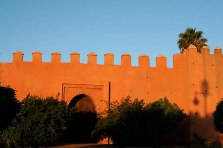 Part of city big wall in Marrakech, Morocco. Sunset