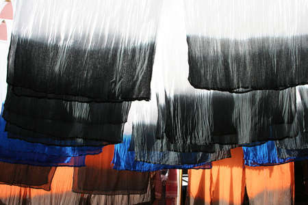 Selection of wonderfully bright colorful cloth at a market stall in Marrakeshの写真素材