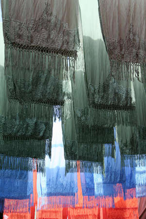 Selection of wonderfully bright colorful cloth at a market stall in Marrakeshの写真素材