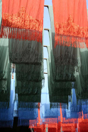 Selection of wonderfully bright colorful cloth at a market stall in Marrakeshの写真素材