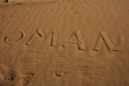 the word OMAN written in the desert sand の写真素材