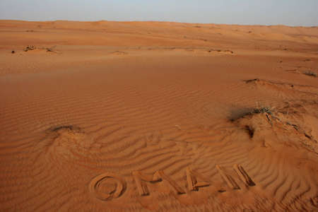 the word OMAN written in the desert sand の写真素材