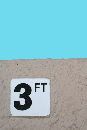 Depth marker warning sign at pool edge for 3 ftの写真素材