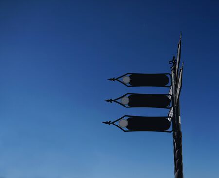 black road sign on the blue skyの写真素材