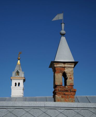 Old and new towers and roof on blue skyの写真素材