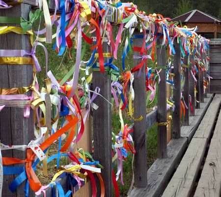 colorful holiday ribbons on a wooden jettyの写真素材