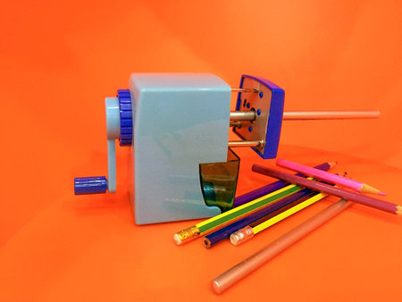 Automatic pencil sharpener with orange backgroundの写真素材