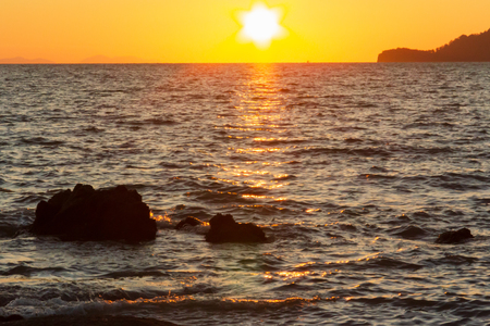 The sun is hiding the beach edgeの写真素材
