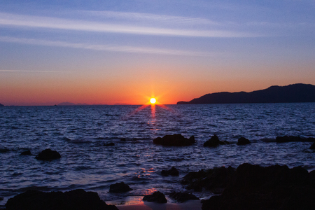 The sun is hiding the beach edgeの写真素材