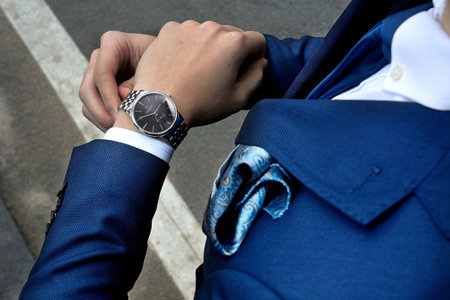 Businessman in suit and watch on his hand. Close-up