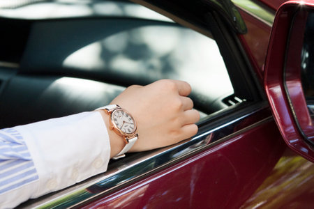 Close up of a woman's hand on the steering wheel of a red carの写真素材
