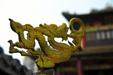 Golden dragon on the roof of an ancient Chinese temple, closeup of photoの写真素材