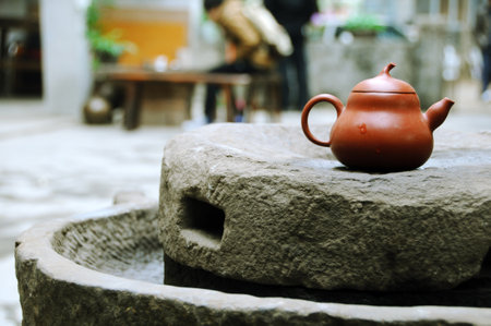 Ceramic teapot on a stone table in a restaurantの写真素材