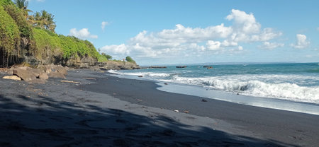 black sand with Blue sky beach in Baliの写真素材