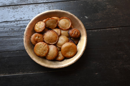 Traditional snacks and sweets of India.  It is made by mixing rice flour and jaggery and frying it...