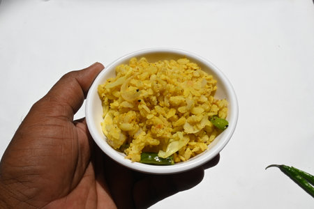 .Vegetable Poha in India. It is made by mixing vegetables, poha and spices. Rice is parboiled before...