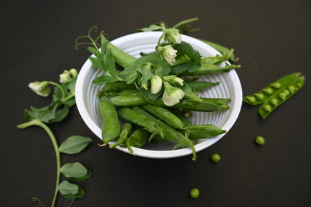 Fresh Green peas on black background. There is a lot of vitamins  and Minerals in it....